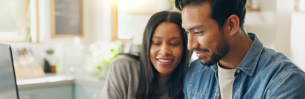 Smiling couple analyzing program options