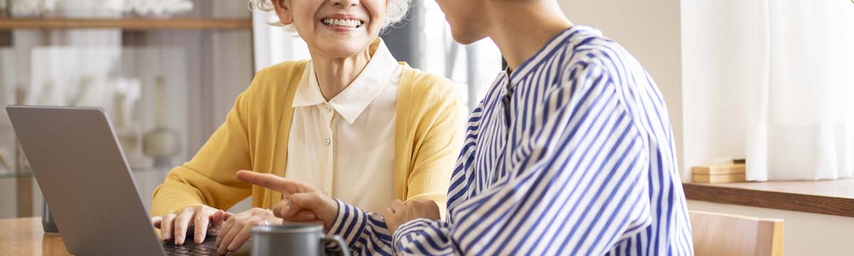 Two women discussing payment assistance options