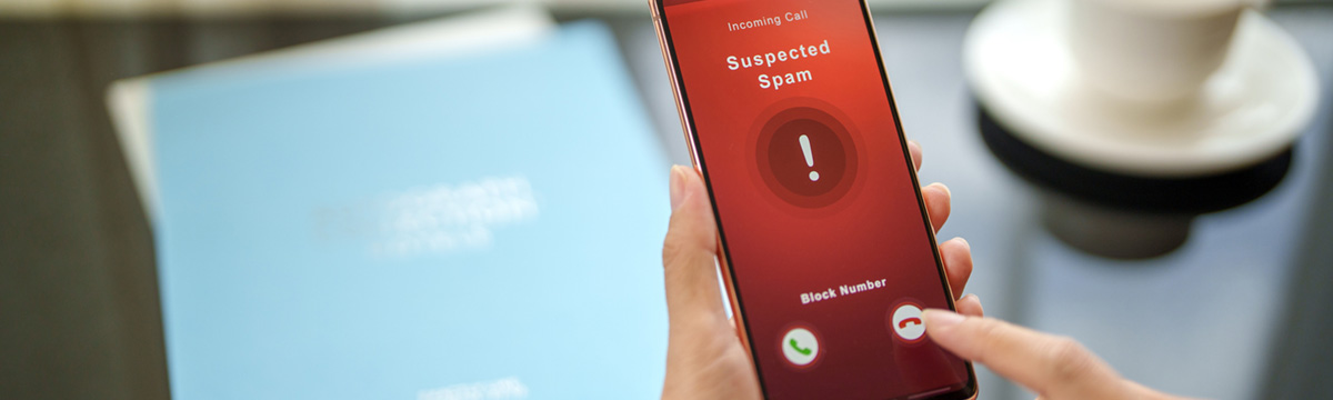 Phone with "suspected scam" on screen