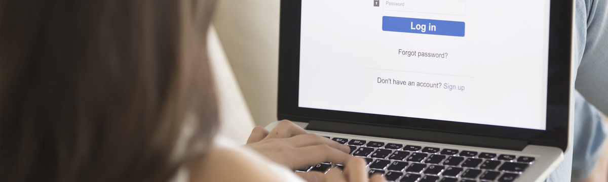 Woman signing into a website on a computer