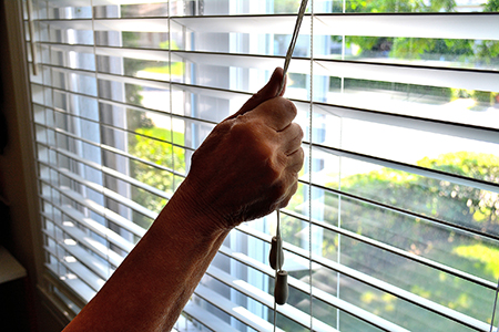 adjusting window blinds
