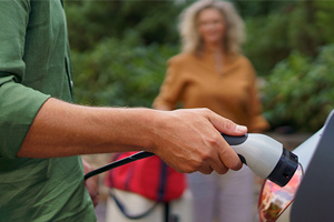 Couple charging their electric vehicle at home